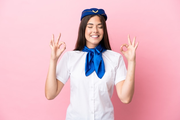 Premium Photo | Airplane stewardess brazilian woman isolated on pink ...