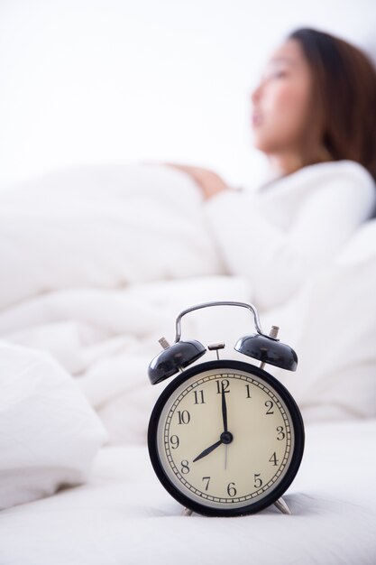 Premium Photo | Alarm clock standing on bedside table