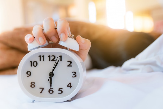 premium-photo-alarm-clock-that-wakes-up-in-the-morning-in-the-bedroom