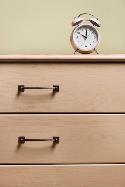 Download Alarm clock on wooden closed drawer Photo | Free Download