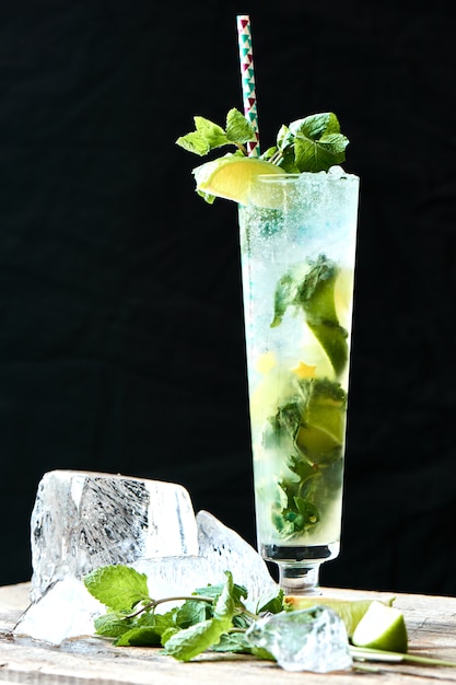 Premium Photo | Alcoholic cocktail mojito in the glass and chunks of ...