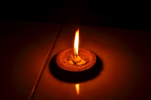 Premium Photo | Alight candles in a row on black background