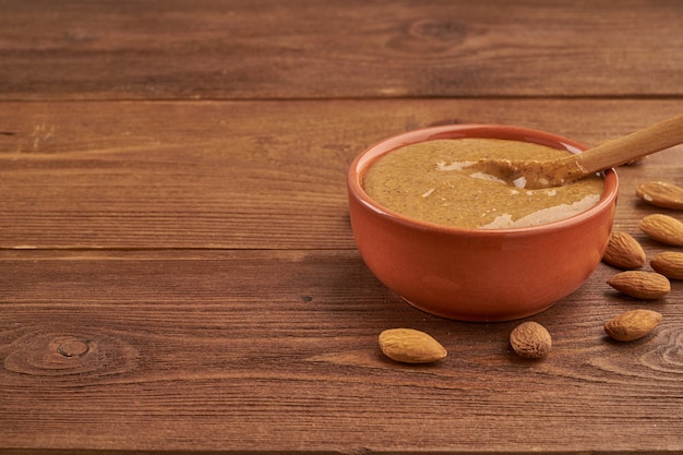 Almond butter, raw food paste made from grinding almonds into a nut butter, crunchy and stir Premium Photo