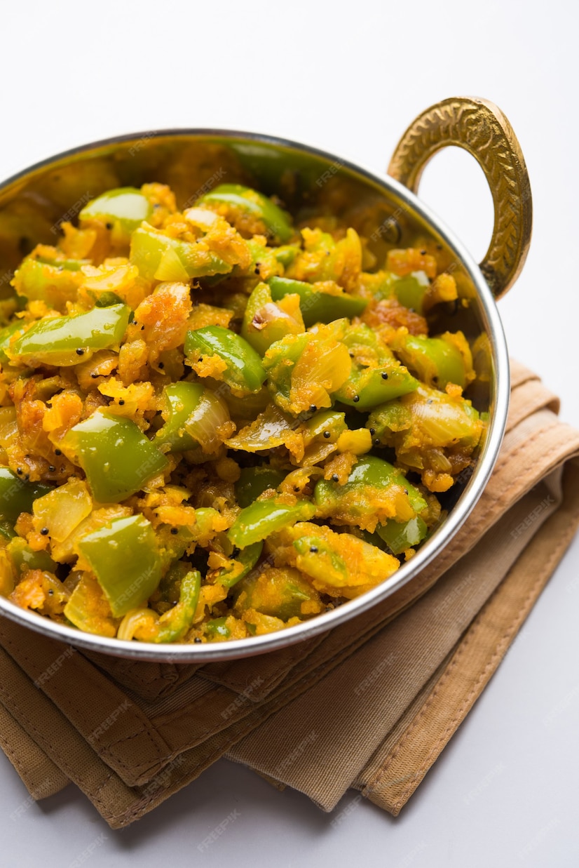 Premium Photo | Aloo capsicum sabzi or potato and bell pepper sabji is ...