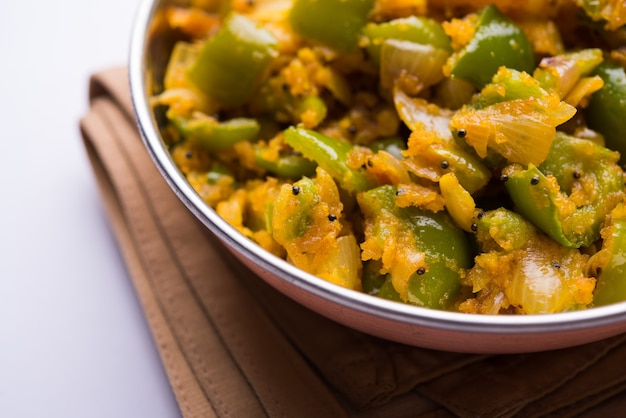 Premium Photo | Aloo capsicum sabzi or potato and bell pepper sabji is ...