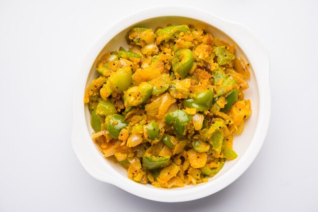 Premium Photo | Aloo capsicum sabzi or potato and bell pepper sabji is ...