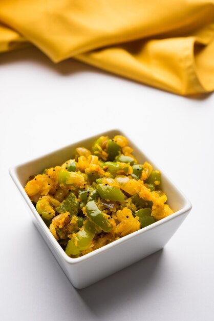 Premium Photo | Aloo capsicum sabzi or potato and bell pepper sabji is ...