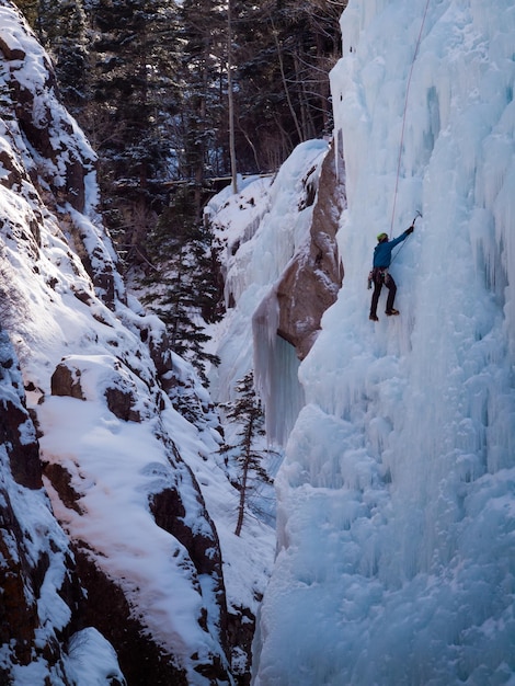 Premium Photo | Alpinist ascenting a frozen waterfall in ice park, ouray.