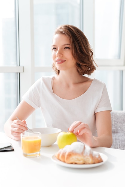 Free Photo | Amazing woman sitting indoors at the table with juice