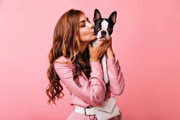 Free Photo | Amazing woman with long wavy hair kissing french bulldog ...