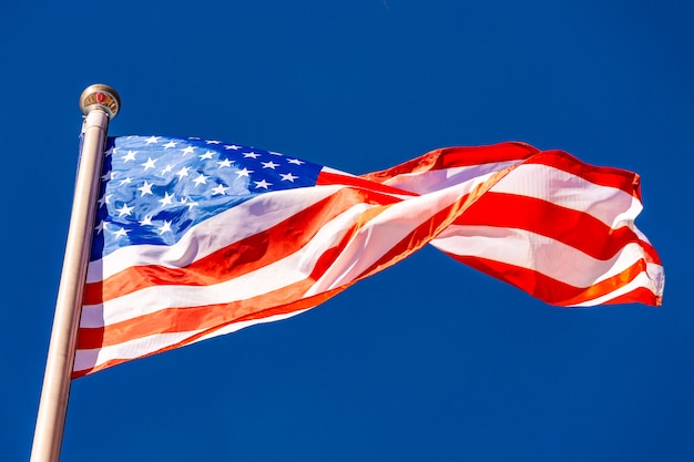 Premium Photo | American flag against blue sky.