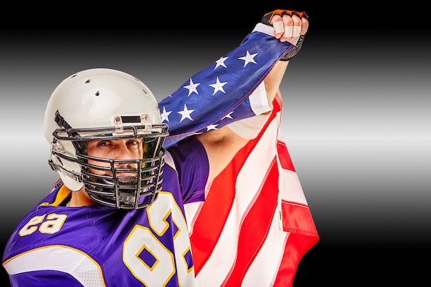 Premium Photo American Football Player Closeup Portrait American Football Player With An American Flag In His Hands Concept Patriotism Celebration