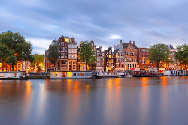 Premium Photo | Amsterdam canal amstel with typical dutch houses and ...