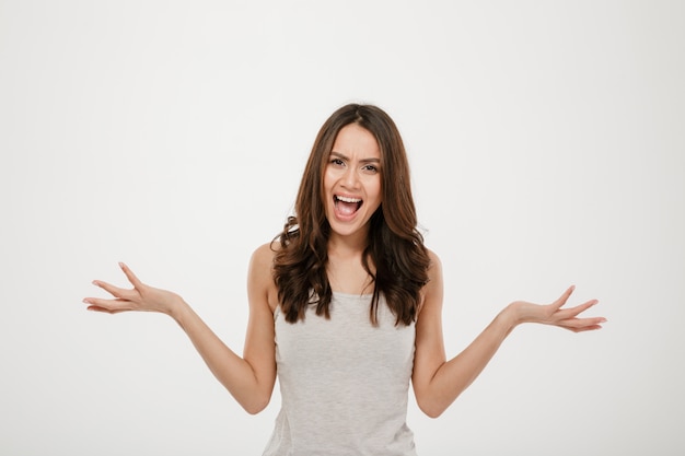 Free Photo | Angry brunette woman screaming and looking at the camera ...