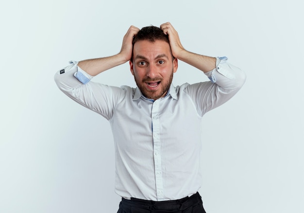 Free Photo | Anxious handsome man holds head looking isolated on white wall