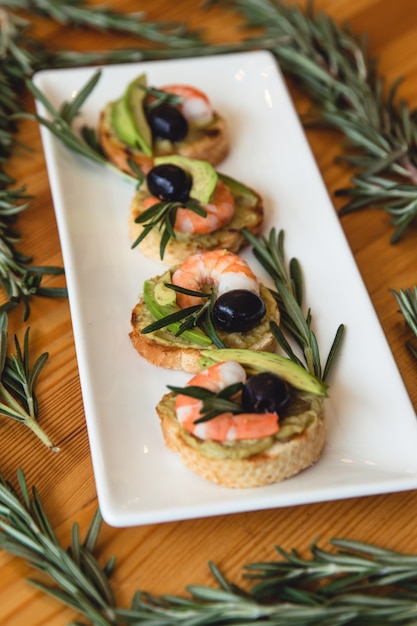 Premium Photo Appetizer Canape With Shrimp And Cucumber On Plate On Table Close Up