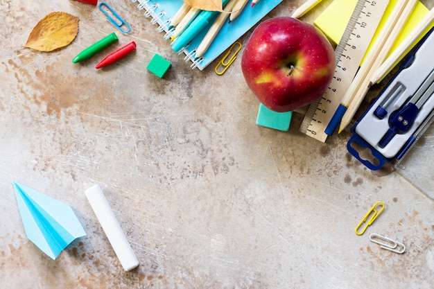 Premium Photo | Apple and school supplies on a table