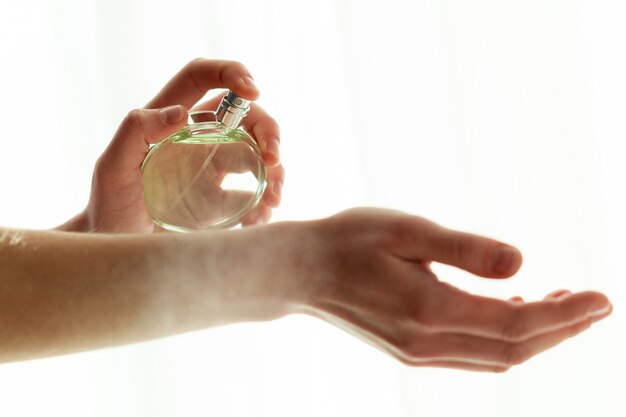 Applying favorite perfume on wrist close up Premium Photo