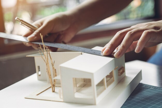 Premium Photo | Architect working on architectural model