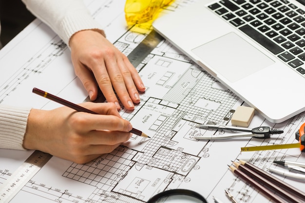 Premium Photo | Architect working on blueprint