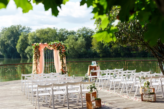 Premium Photo | Area of the wedding ceremony near river on the pier ...