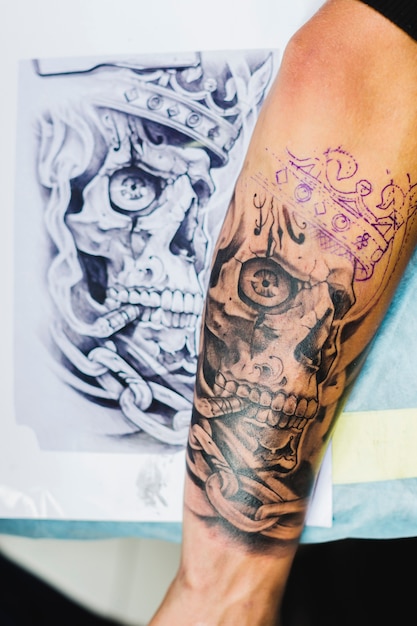 Free Photo | Arm with tattoo near the sketch