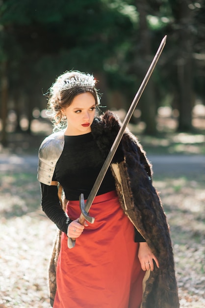 Premium Photo | Armed medieval woman warrior in armor posing while ...