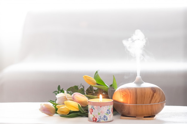 Aroma oil diffuser lamp on the table . Free Photo