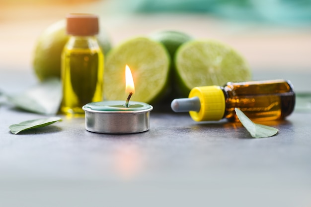 Aromatherapy herbal oil bottles aroma with lime lemon essential oils Premium Photo