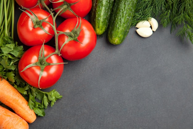 Arrangement of mixed colorful vegetables, isolated on dark gray slate stone background with empty copy space. banner Premium Photo