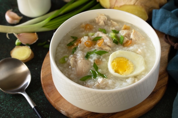 Premium Photo | Arroz caldo soup closeup hot soup with ginger chicken ...