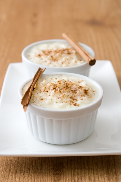 Premium Photo | Arroz con leche rice pudding with cinnamon on wood