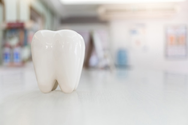 Artificial teeth model on wood table with blur background Premium Photo
