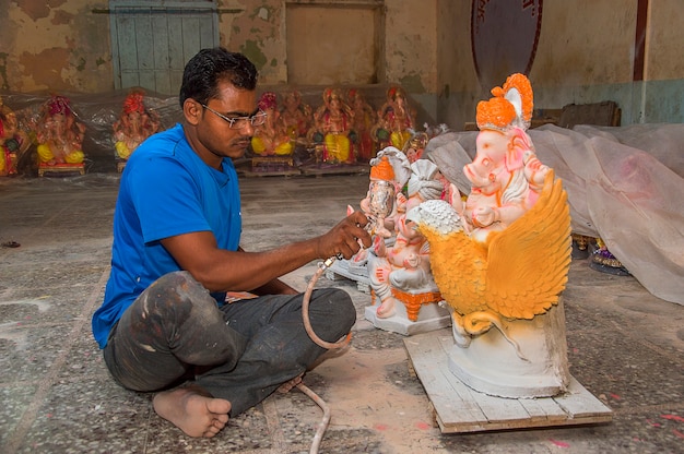 Premium Photo Artist Making A Statue And Gives Finishing Touches On An Idol Of The Hindu God 7415