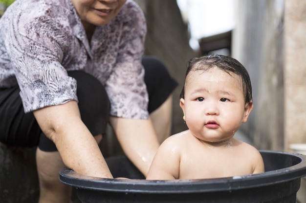 premium-photo-asian-baby-take-a-bath-in-the-outside