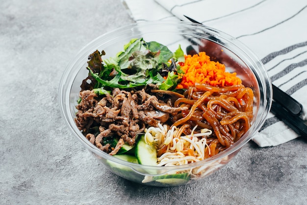 Premium Photo | Asian buddha bowl on gray baclground. grilled beef ...