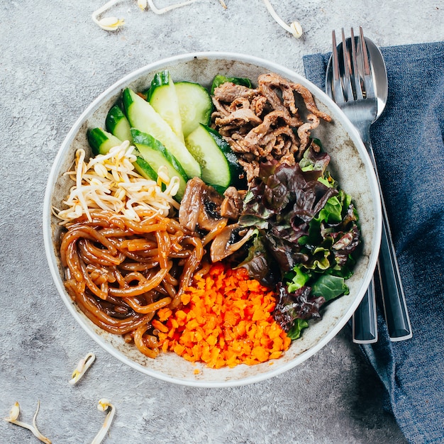 Premium Photo | Asian buddha bowl on gray baclground. grilled beef ...