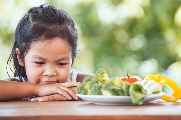 Premium Photo | Asian child does not like to eat vegetables and refuse ...