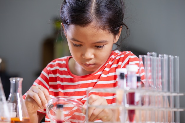 Premium Photo | Asian child girl making chemical experiment in the ...