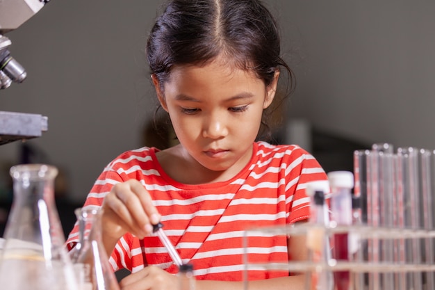 Premium Photo | Asian child girl making chemical experiment in the ...