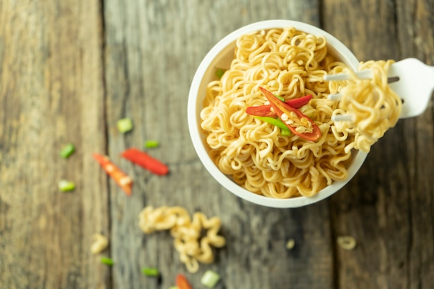 Premium Photo Asian Cup Noodles With A Plastic Fork On Wooden