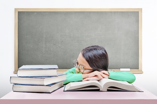 Asian Cute Girl With Glasses Fall Asleep On Book On The Desk Photo