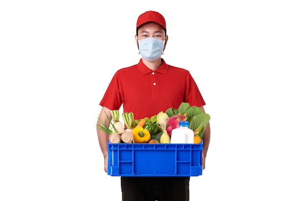 Asian delivery man wearing face mask in red uniform ...