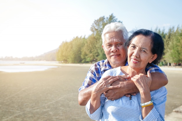 Premium Photo Asian Elderly Couple Hugging Each Other By The Sea