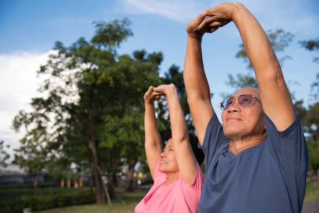 Premium Photo | Asian elderly people stretching before exercise.