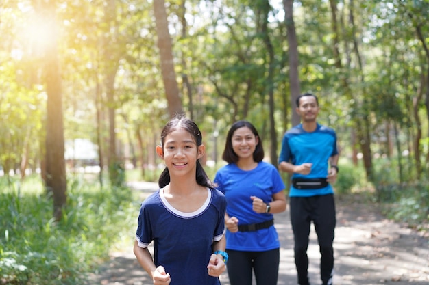 Premium Photo | Asian family exercising and jogging together at the park