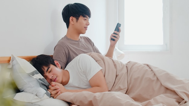 Free Photo Asian Gay Couple Using Mobile Phone At Home Young Asia Lgbtq Man Happy Relax Rest After Wake Up Check Social Media While His Boyfriend Sleep Lying On Bed In