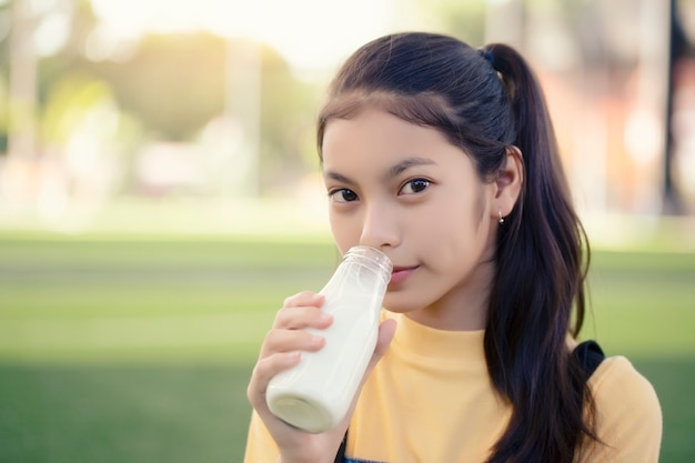 Premium Photo An Asian Girl Is Drinking A Delicious Bottle Of Milk