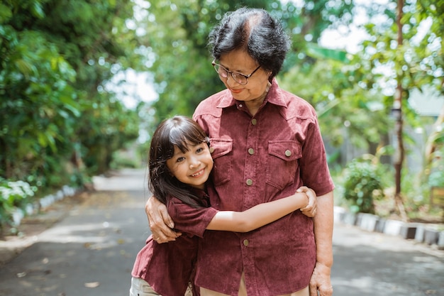 Premium Photo | Asian grandmother and grandchild walking together in ...