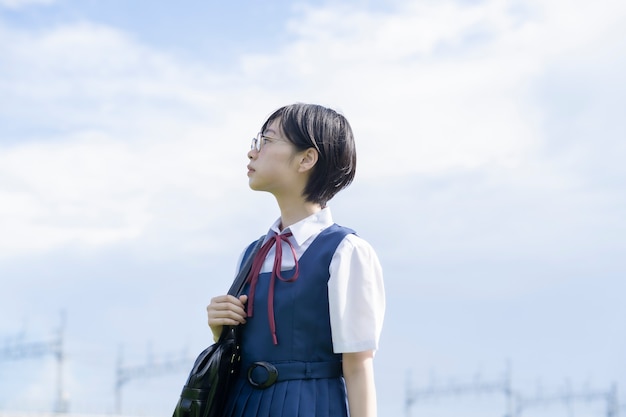 空を見上げる眼鏡をかけたアジアの女子高生 プレミアム写真